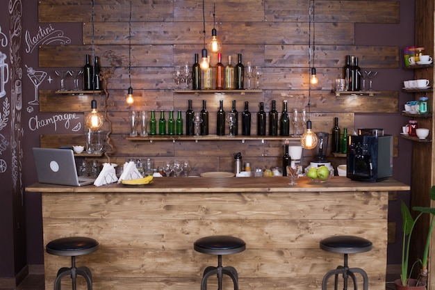 Coffee shop bar counter with wine bottles. Modern design. Vintage atmosphere.