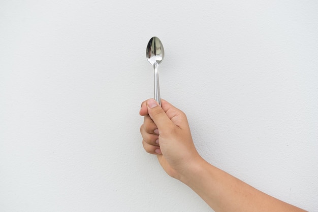 Coffee spoon in hand on white background