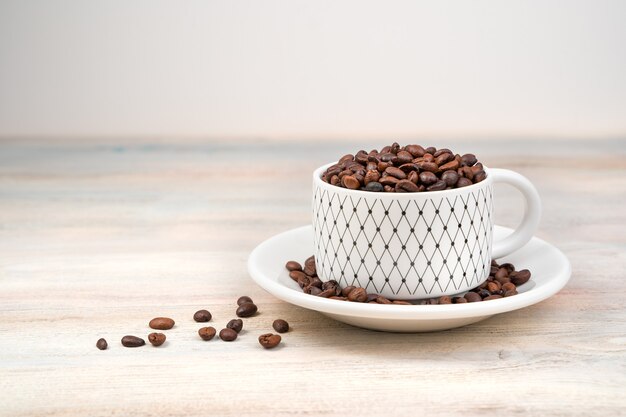 Coffee table, Coffee beans are poured into a Cup . Side view.