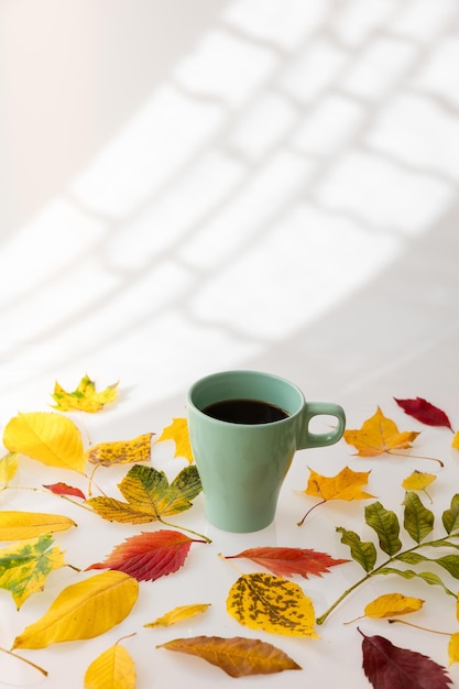 Coffee on a white background with autumn leaves. autumn background