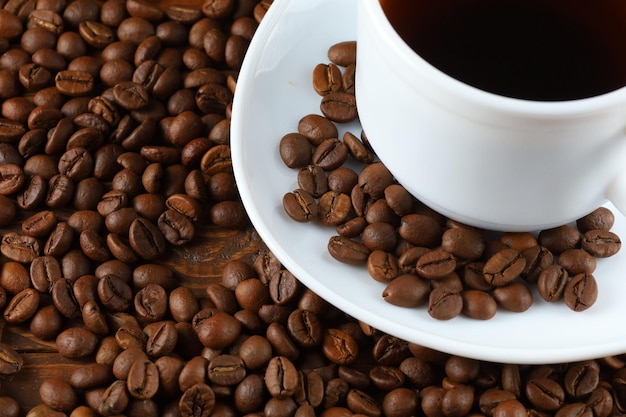 Coffee in a white cup and coffee beans