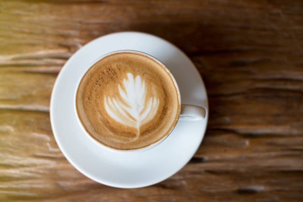 Coffee in white cup on wooden table