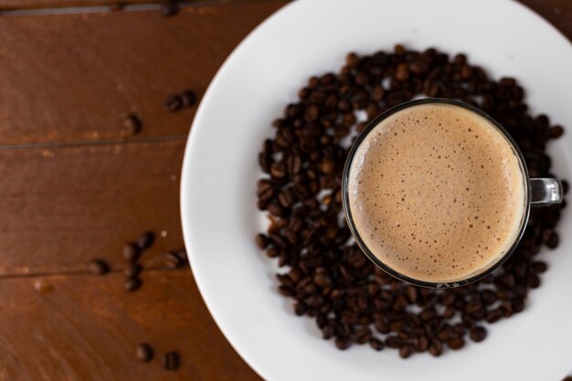 Coffee on a white plate with beans around