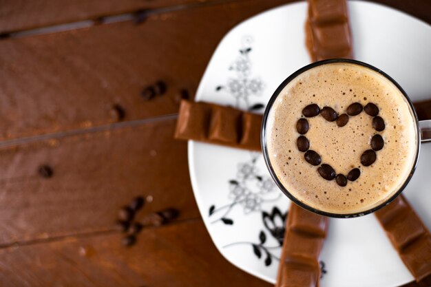 Coffee with a heart on a wooden background