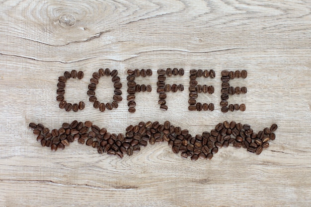 Coffee words letter made from coffee beans on wooden background