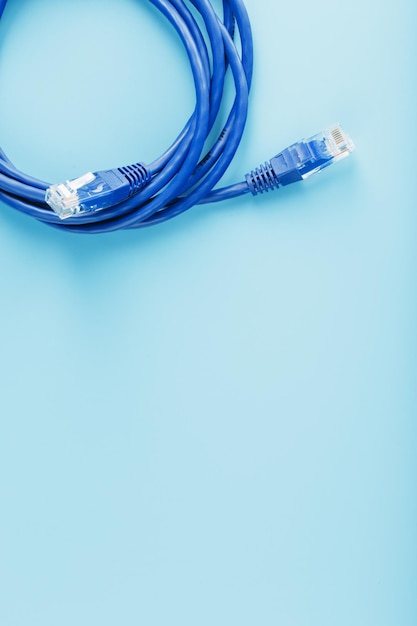 A coil of an Internet network cable for data transmission on a blue background