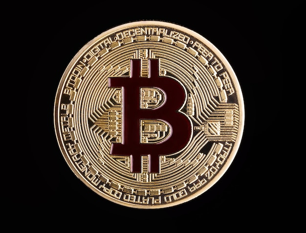 Coin bitcoin made of gold isolated on a black background