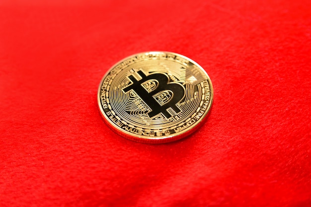 Coin bitcoin on a red background