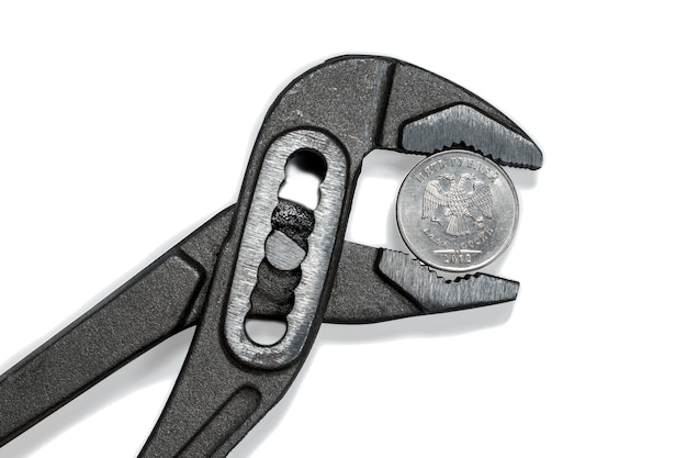 Coin in vise isolated as a symbol of economic sanctions against of Russia