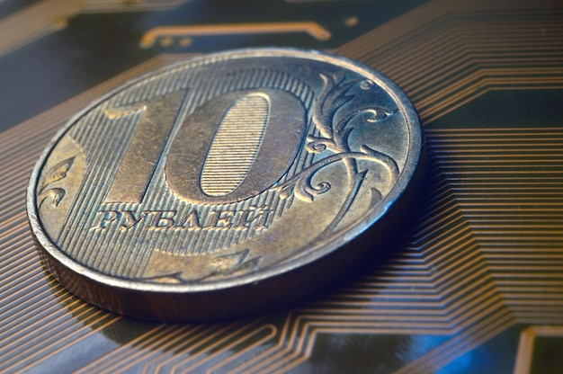 A coin with a face value of 10 rubles lies on a microcircuit closeup Translation of the inscription on the coin quot10 rublesquot The concept of the digital economy in the Russian Federation