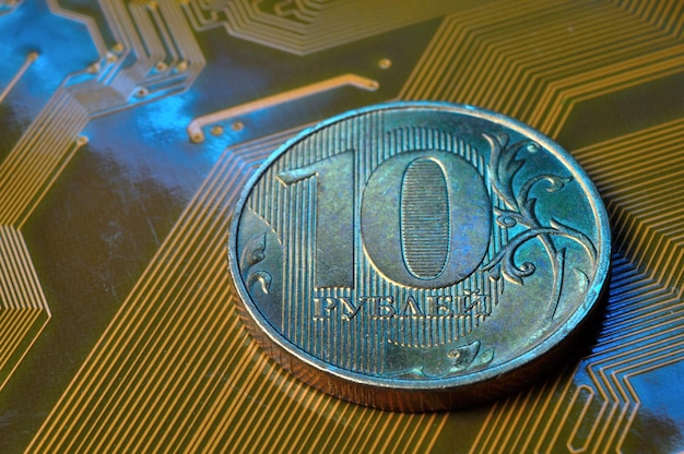 A coin with a face value of 10 rubles lies on a microcircuit closeup Translation of the inscription on the coin quot10 rublesquot The concept of the digital economy in the Russian Federation