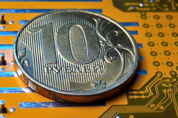 A coin with a face value of 10 rubles lies on a microcircuit closeup Translation of the inscription on the coin quot10 rublesquot The concept of the digital economy in the Russian Federation