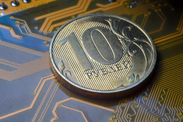 A coin with a face value of 10 rubles lies on a microcircuit closeup Translation of the inscription on the coin quot10 rublesquot The concept of the digital economy in the Russian Federation