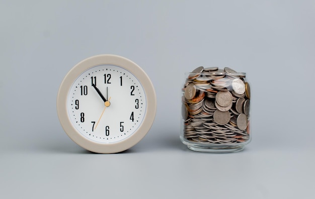 Coins and an alarm clock savings concept finance finance business