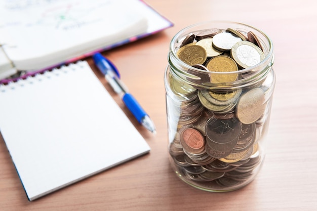 The coins are stored in a glass jar to accumulate finances