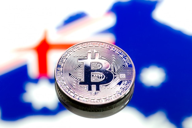 coins Bitcoin over Australia and the Australian flag, concept of virtual money, close-up. Conceptual image.