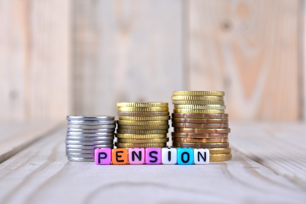 Coins and cube dices with word pension