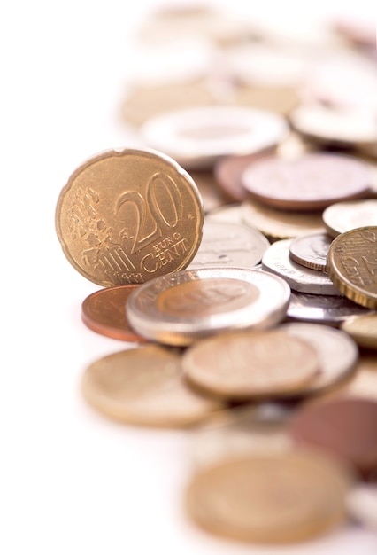 Coins of different countries on a white background.