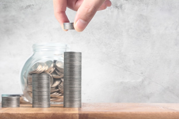 Coins in glass jar and piles of coins