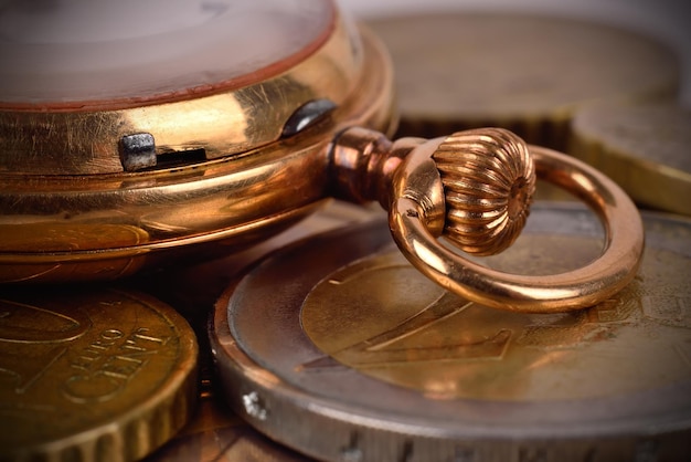 Coins and golden pocket watch