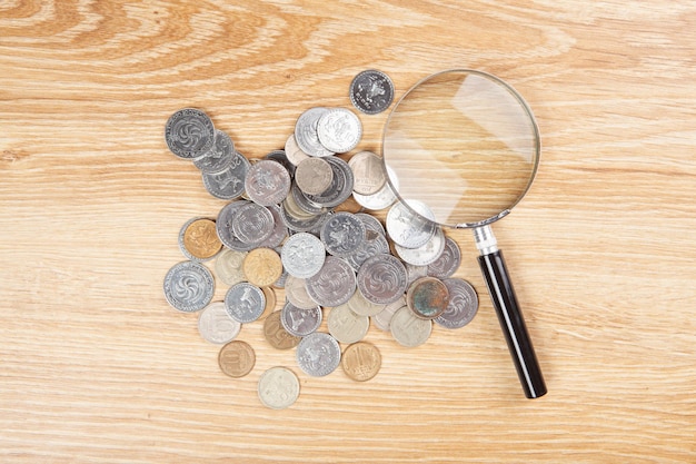 coins and a magnifying glass on the table