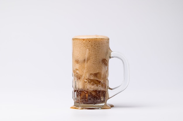 Cola in glass with clear ice cubes isolated on white background