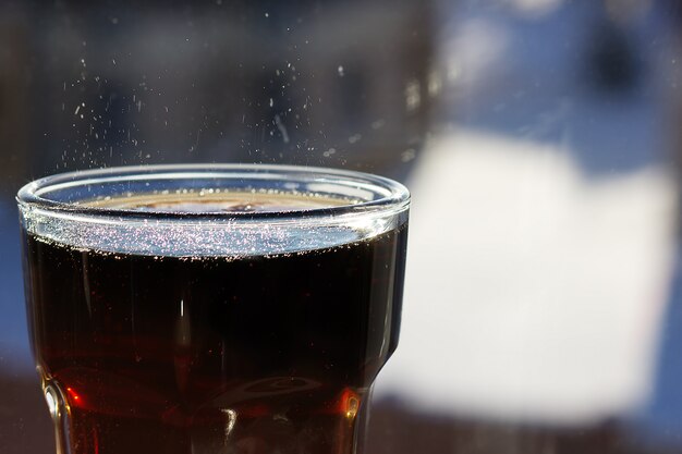 Cola in glass with splashes