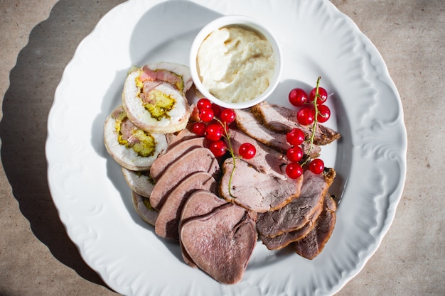 Cold appetizer with chopped beef tongue currants and white sauce