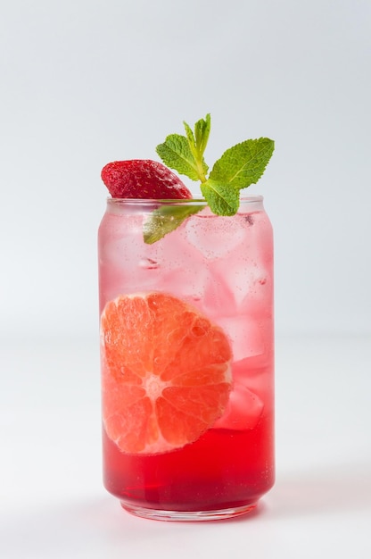 Cold cocktail with ice soda grapefruit and strawberries