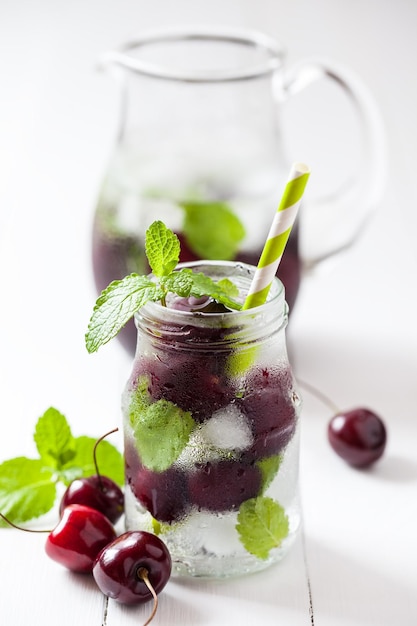 Cold drink with straw cherry summer refreshing cocktail