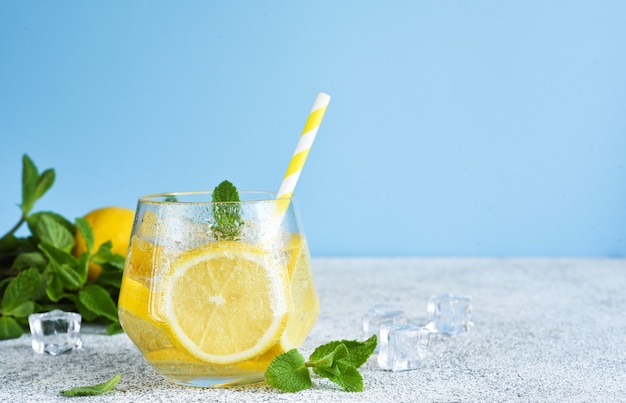 Cold lemonade with mint and lemon juice. Fresh summer drink. Mahito with lemon.