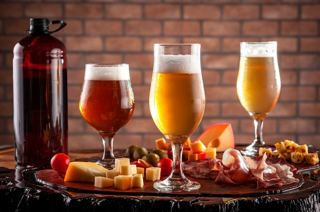 Cold platter with draft beer on a wooden cutting board