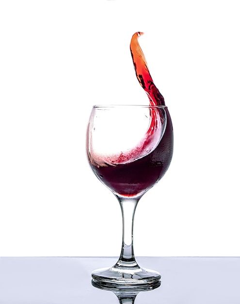 cold red dry wine in a glass on a white background