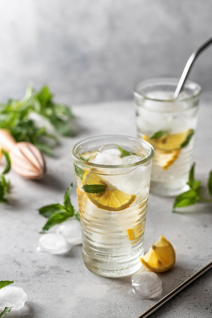 Cold and refreshing detox water with lemon mint and ice Homemade lemonade or cocktail Copy space