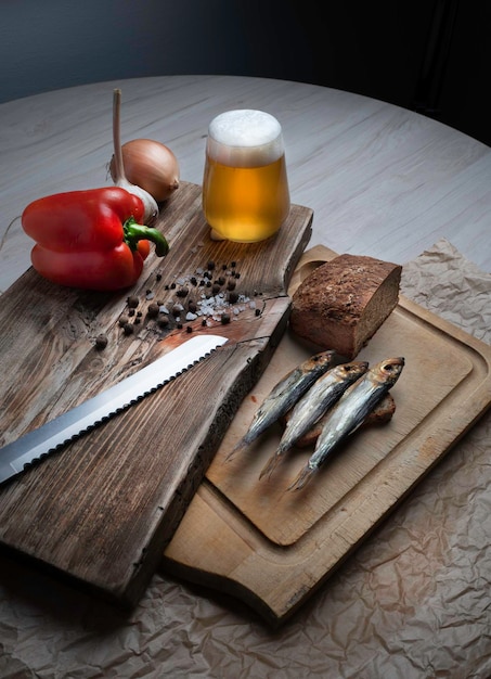 Cold smoked fish on an old wooden board with spices