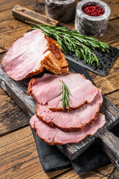 Cold Smoked pork sirloin meat with herbs on rustic board Wooden background Top view