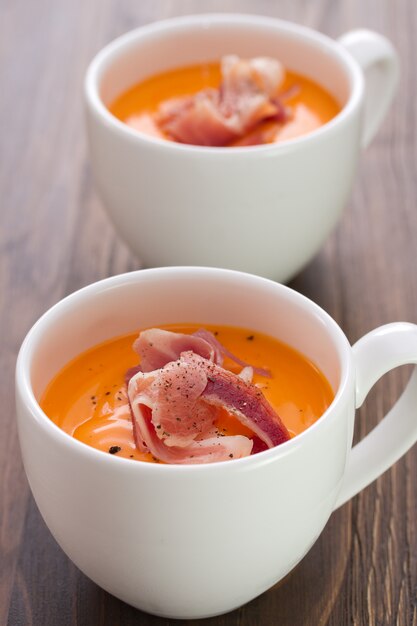 Cold soup with smoked meat and black pepper in white cup