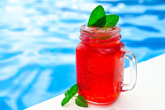 Cold strawberry lemonade in mason jar isolated