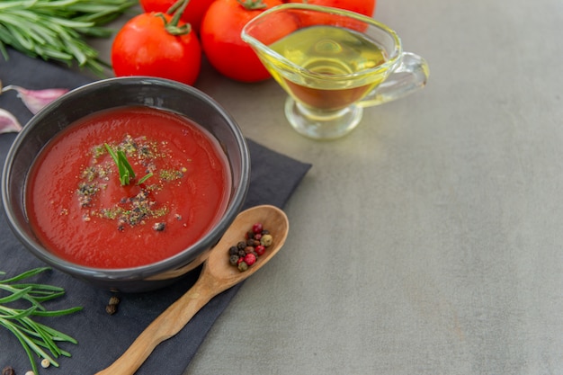 Cold tomato gazpacho soup in a deep plate. Traditional Spanish cuisine. The concept of Spanish cold soup of ripe tomatoes. Copy space, close-up.