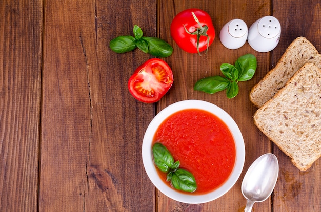 Cold tomato soup on wooden surface