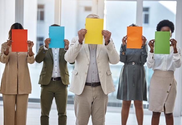 Collaboration paper and an anonymous business team standing in the office together to show selection options Teamwork mockup and color poster with a group of colleagues or employees at work