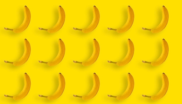 A collage of bananas on a yellow background monochrome and minimalism in advertising