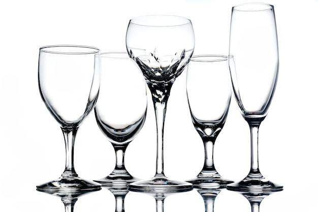 Collage of empty glasses on white background.