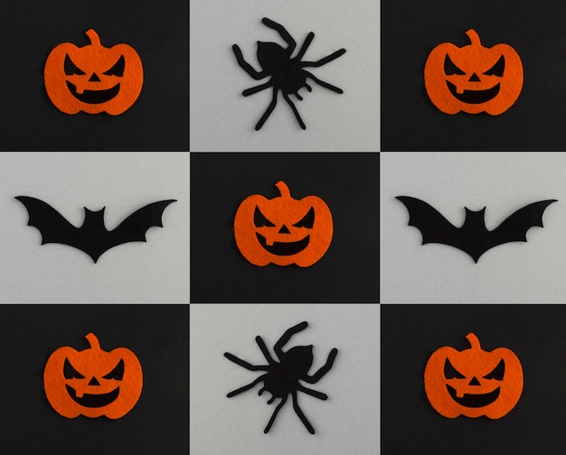 Collage for Halloween Decorative spiders pumpkins and bat on the black and gray background Copy space Top view