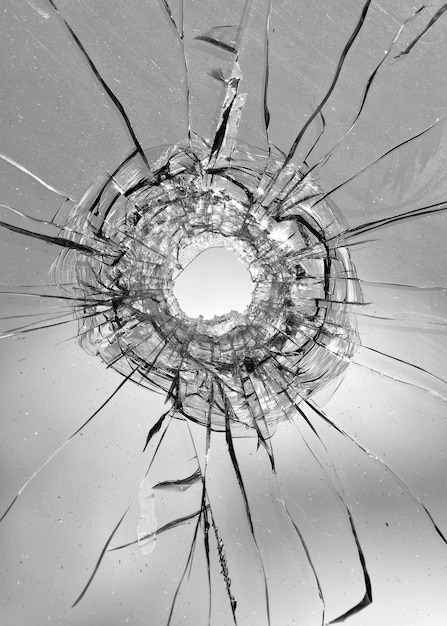 Collage Hole from a ball in the glass, cracks on a white background