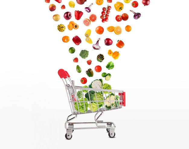 Collage of shopping cart with vegetables and fruits isolated