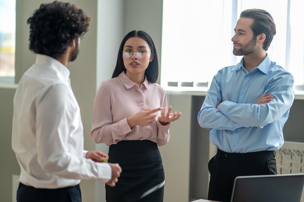 Colleagues. Business colleagues talking in the officce and looking involved