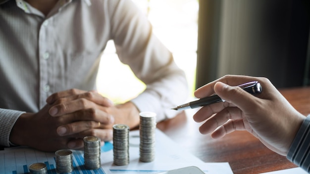 Colleagues calculating currency in office