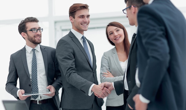 Colleagues shaking hands in office