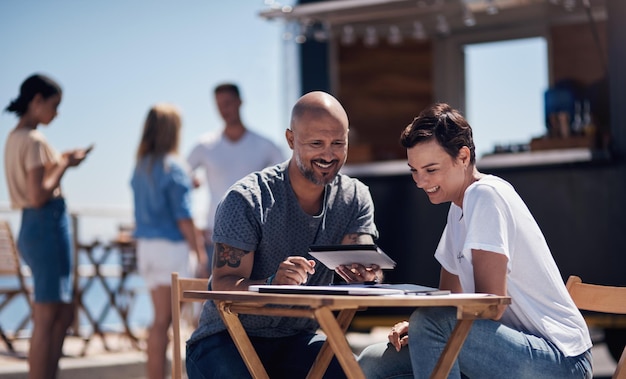 Colleagues tablet and reading with smile outdoor and review of statement for small business in summer Partner man and check for bills of store paperwork and working on table and food truck